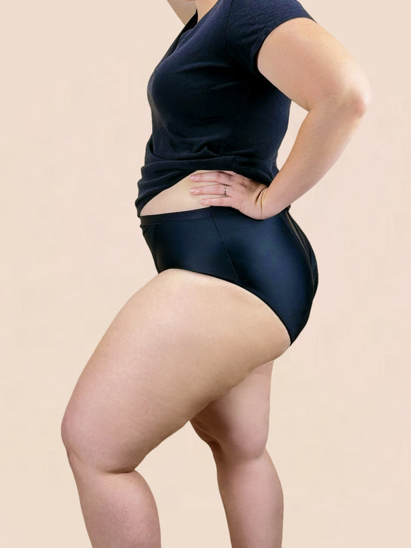 Model wears the prolapse support underwear from Hem Support Wear. Side view of model wearing Curvy 1x